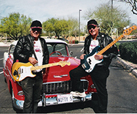 two twin musicians with guitars and classic fifty five chevy